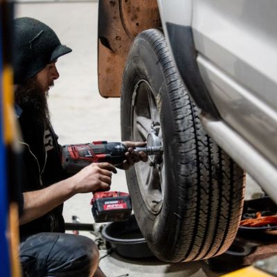 Tonz of Tread service technician changing a tire